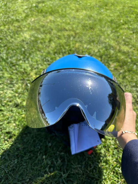 Low angle of blue AeroPro Safety Helmets with Smoke Visor Kit on Grass. ANSI/ISEA Z89.1-2014 Type 1 Class C Safety Helmet with Smoke Visor used for Construction, Rescue & Arborist. 